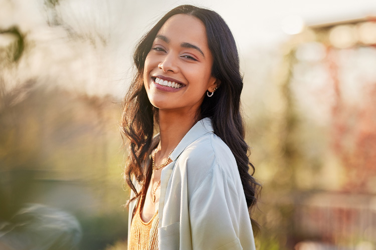 Adult woman smiling after receiving mental health support for depression, anxiety, and ADHD, reflecting positive outcomes and improved well-being.